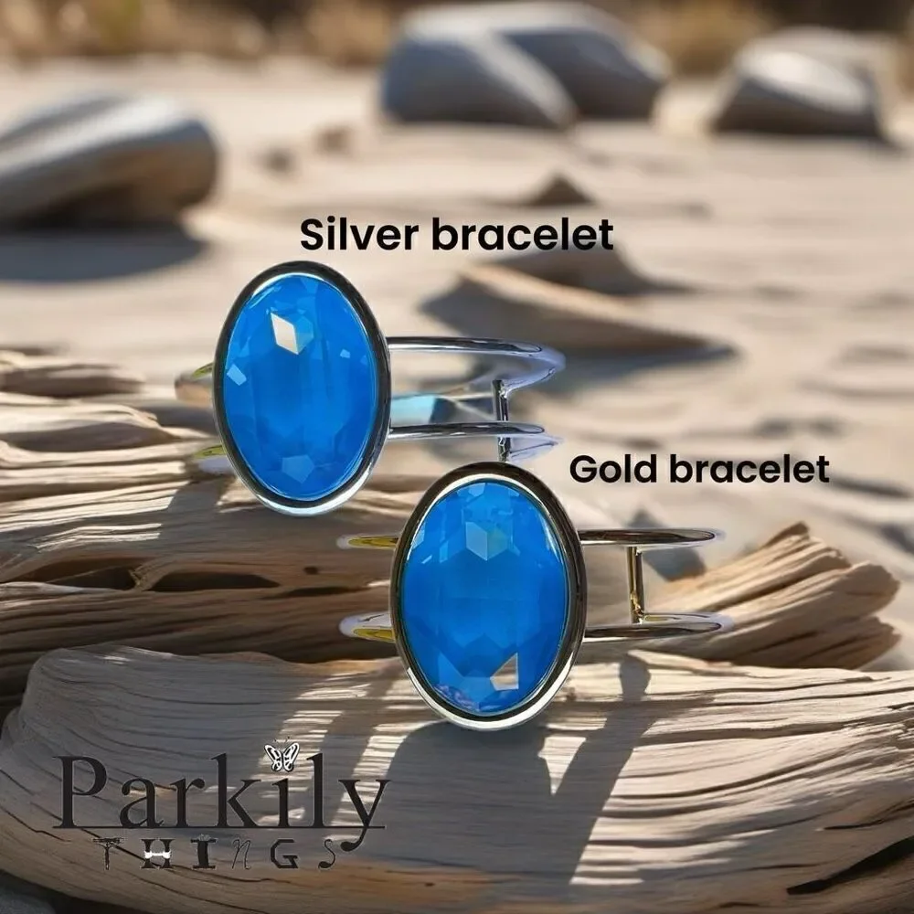 A Gold Handcrafted bracelet with large oval blue Swarovski crystal